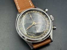 Orologio cronografo vintage SS Croton con quadrante nero dorato.