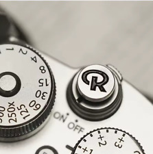 Pulsante otturatore a rilascio