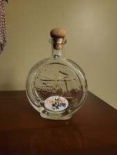 Limoncello bottle with cork and designs on both sides stamped and has cork 