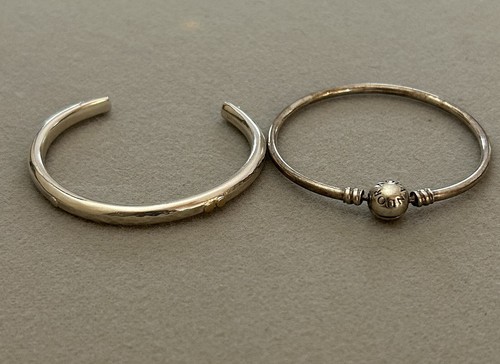 Two silver bracelets one - two,