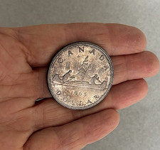 1965 MONETA DOLLARO D'ARGENTO