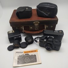 Corredo fotografico Ashai Pentax mod. Auto 110 + 3 ottiche + valigetta in pelle