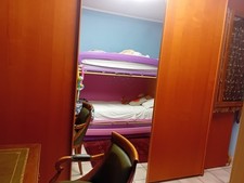 armadio a 3 ante scorrevoli con antra centrale a specchio e due cassettiere 