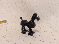 Barboncino kitsch vintage nero oro altalena da passeggio giocattolo in plastica