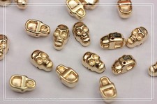 100pz Borchie sfuse forma teschi da cucire colore ORO 1,2cmX0,7cm