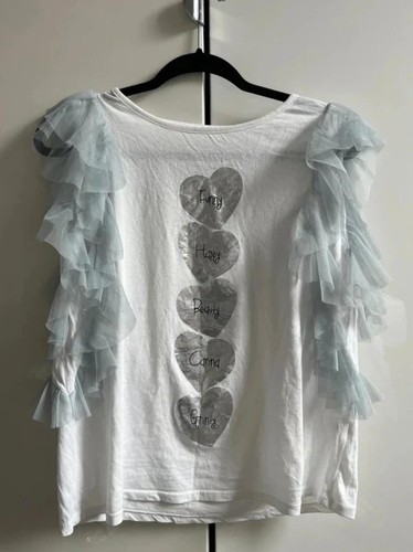 Top bianco con volant stampa