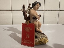 Statuetta porcellana Capodimonte putto seduto con ali (Medea con cartellino)
