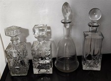 4 Bottiglie in cristallo ,molature di pregio ,forme differenti e originali