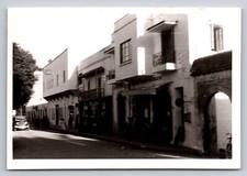 Antique Car Driving Down City