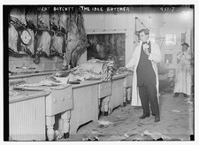 Butcher stands idle before his