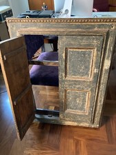 Antico stipo a muro in legno bugnato. Copertura per nicchia a parete.