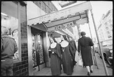 Nuns walking under entrance