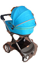Trio Stokke. Passeggino e Babypullman azzurro, Ovetto grigio e Accessori