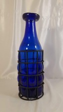 Grande bottiglia in vetro blu soffiato in griglia metallica colore nero con b