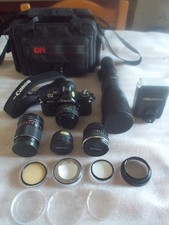 CANON AV1 REFLEX + TELEOBIETTIVO + FLASH + TELE CONVERTER + FILTRI + BORSA ECC..