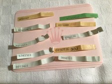 ROLEX LOTTO N. 10 ADESIVI USATI CON SERIALE DA METTERE SUL TAG LOGO A RILIEVO 