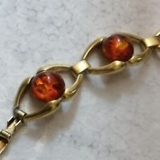 Antico bracciale color oro con sfere di colore ambra degli anni 50