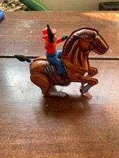 Giocattolo cavallo cowboy in latta a molla d'epoca