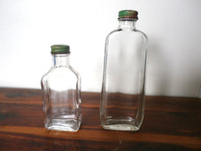 TWO EMPTY BOTTLES OF ALMOND