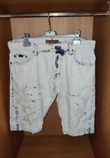 Jeans strappati bianchi con macchie blu