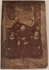 V02-Ferrotype Family Group Man Lady chil beard mustaches tie cap jacket backdrop