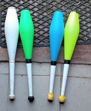 quattro clave da giocoleria, usate, una bianca, tre colorate