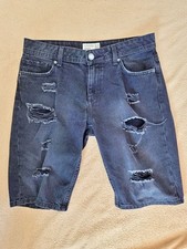 Shorts in jeans neri strappati Terranova