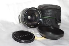 Objectif M42 28mm f2,8 SOLIGOR bouchons et étui cuir d'origine +pare-soleil TBE
