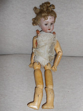 Antica bambola in legno di cartapesta con testa in porcellana completamente articolata