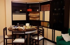 camera soggiorno completa con mobili, vetrinette, tavolo rotondo e 6 sedie