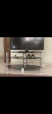 Tavolino porta tv tre ripiani vetro nero e acciaio satinato . Prezzo 40 euro .