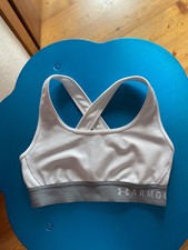 Armour reggiseno sportivo bianco con fascia elastica grigia.Incrociato sul retro
