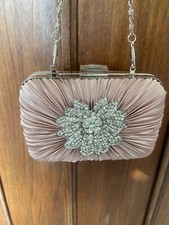 Pochette rigida  in raso rosa con decorazione e catenella. Dimensioni 14x9x5 cm.