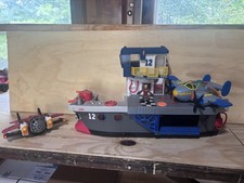 Fisher-Price Imaginext Sky Racers portaerei con 2 aerei e personaggio