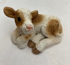 Statuina seduta in vitello