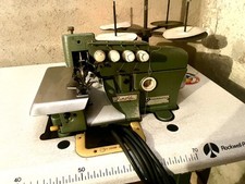 Macchina da cucire taglia e cuci elettrica  Rimoldi con mobile e supporto fili