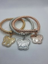 TRIS BRACCIALI ELASTICI COLORE ORO/ARGENTO/RAME CON CHARMS