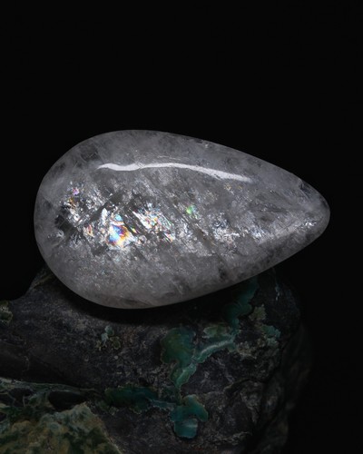 Arctic natrolite cabochon hand - arctic,