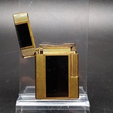 Accendino Dupont dorato e nero lacca di china. Ammaccature e graffi