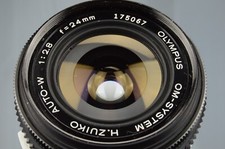 Olympus Zuiko 24mm f:2,8 Grandangolo N°175067 + Filtro UV Made in Japan 1980s