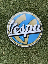 A VESPA MOTOR SCOOTER ROUND