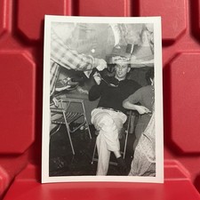 Man Sitting In A Chair Holding