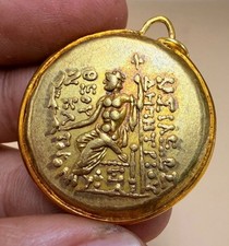 Moneta dorata stile greco