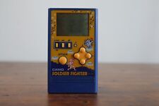 Sistema di gioco LCD portatile vintage CASIO (SOLDIER FIGHTER) CG-86 1984 - Argentina.