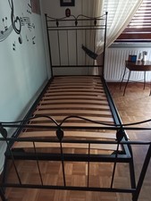 Letto in ferro battuto con rete in doghe in legno e un comodino.Regalo materasso