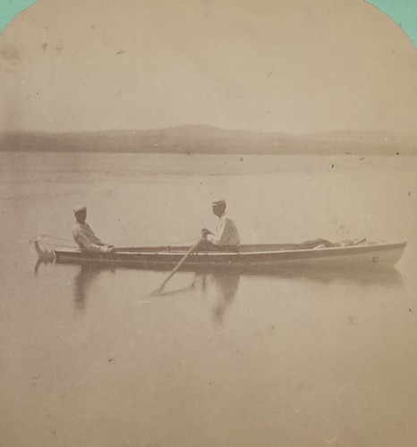 Two men long boat - a,