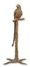 Una scultura in bronzo raffigurante un pappagallo su un ramo replica design retr