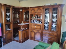 mobile angolo bar con specchio e ampio mobile in legno con vetri e mensole.