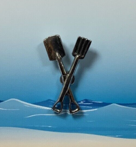 Crossed pitch fork and spade - and,