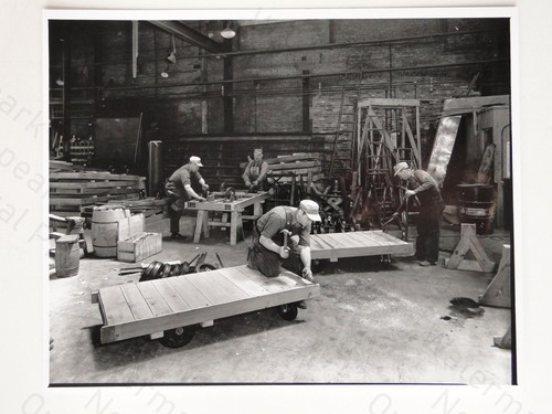 Workers building carts - building,